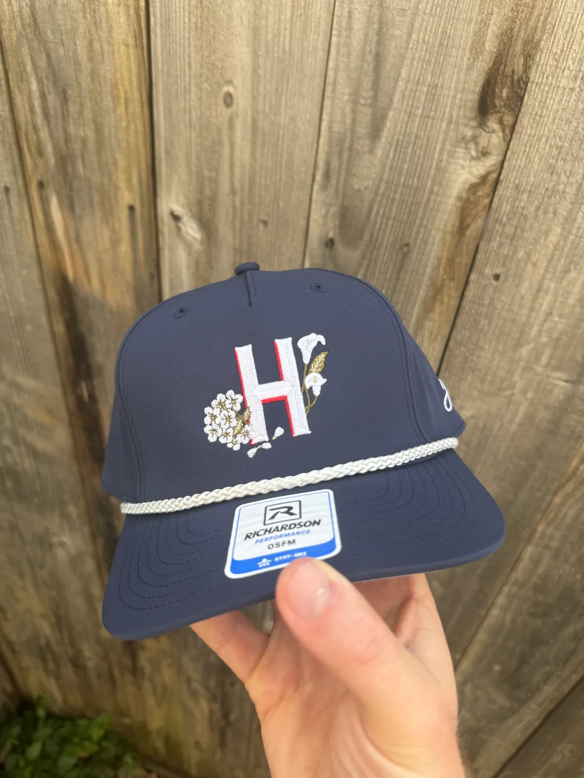 Navy event hat with embroidered monogram and rope detail