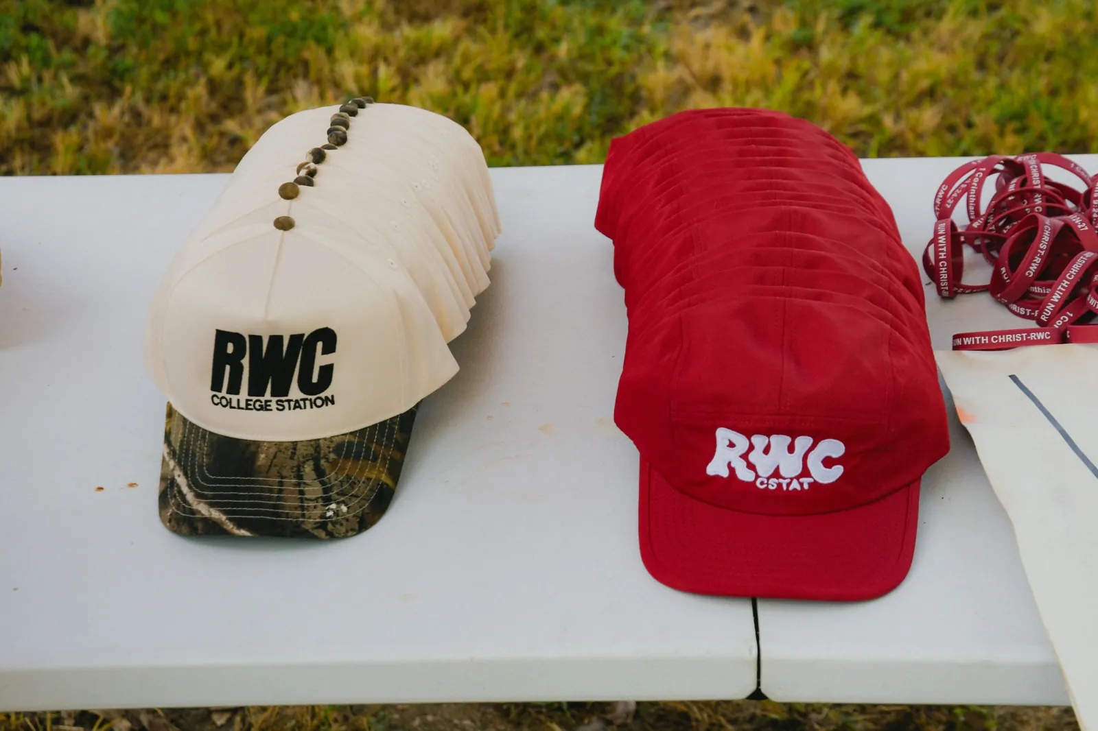 Two finished business hat runs arranged in rows at an outdoor event