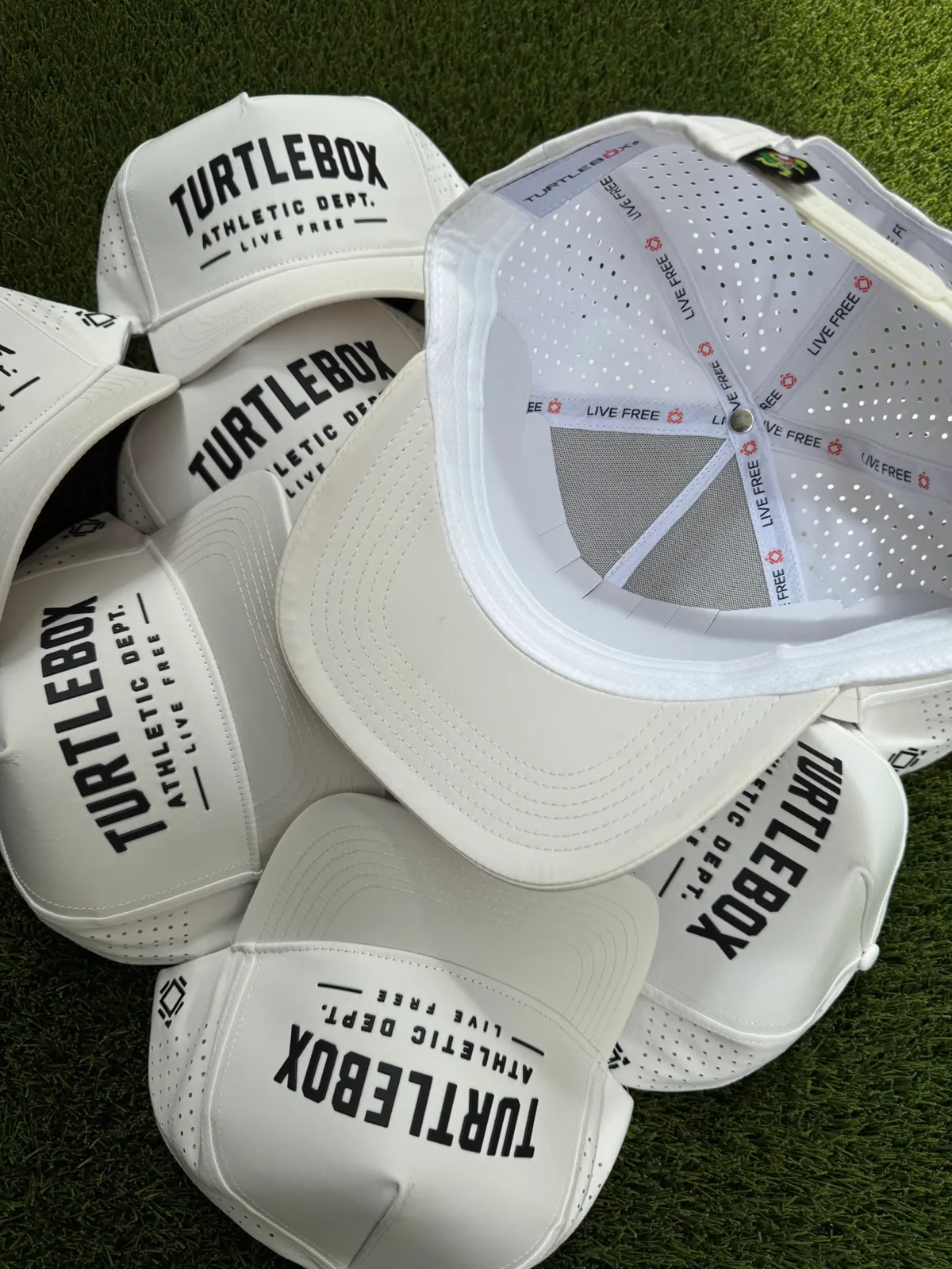 Turtlebox custom hats stacked on turf