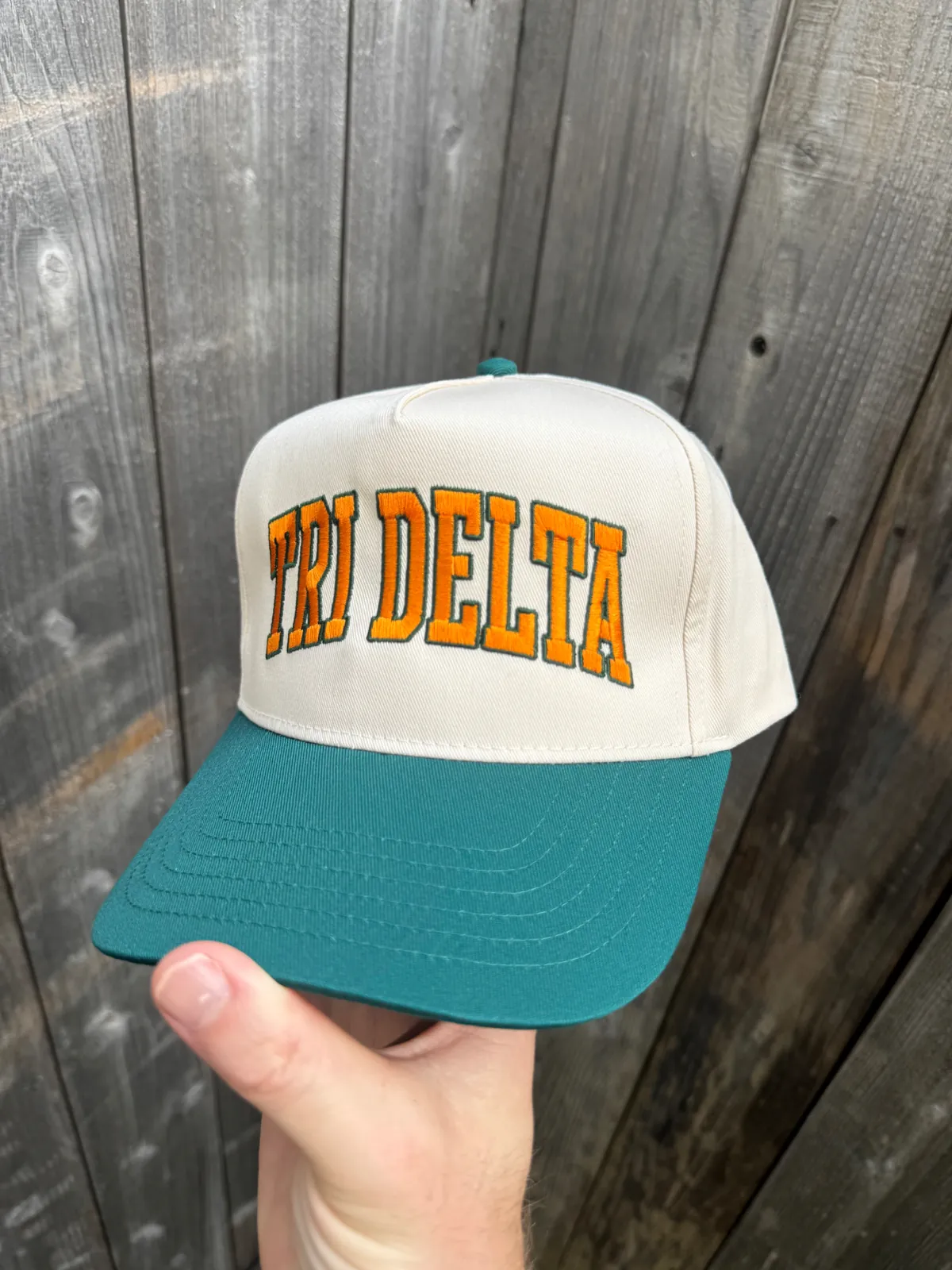 Cream and teal two-tone hat with orange 3D puff collegiate lettering