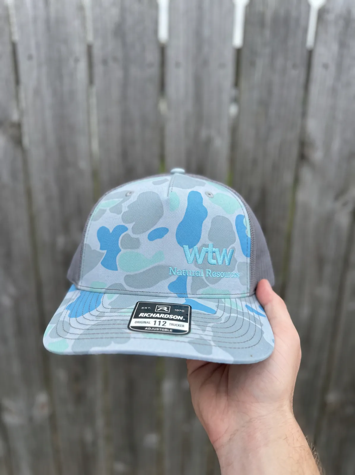 Blue camouflage corporate trucker hat with front embroidery