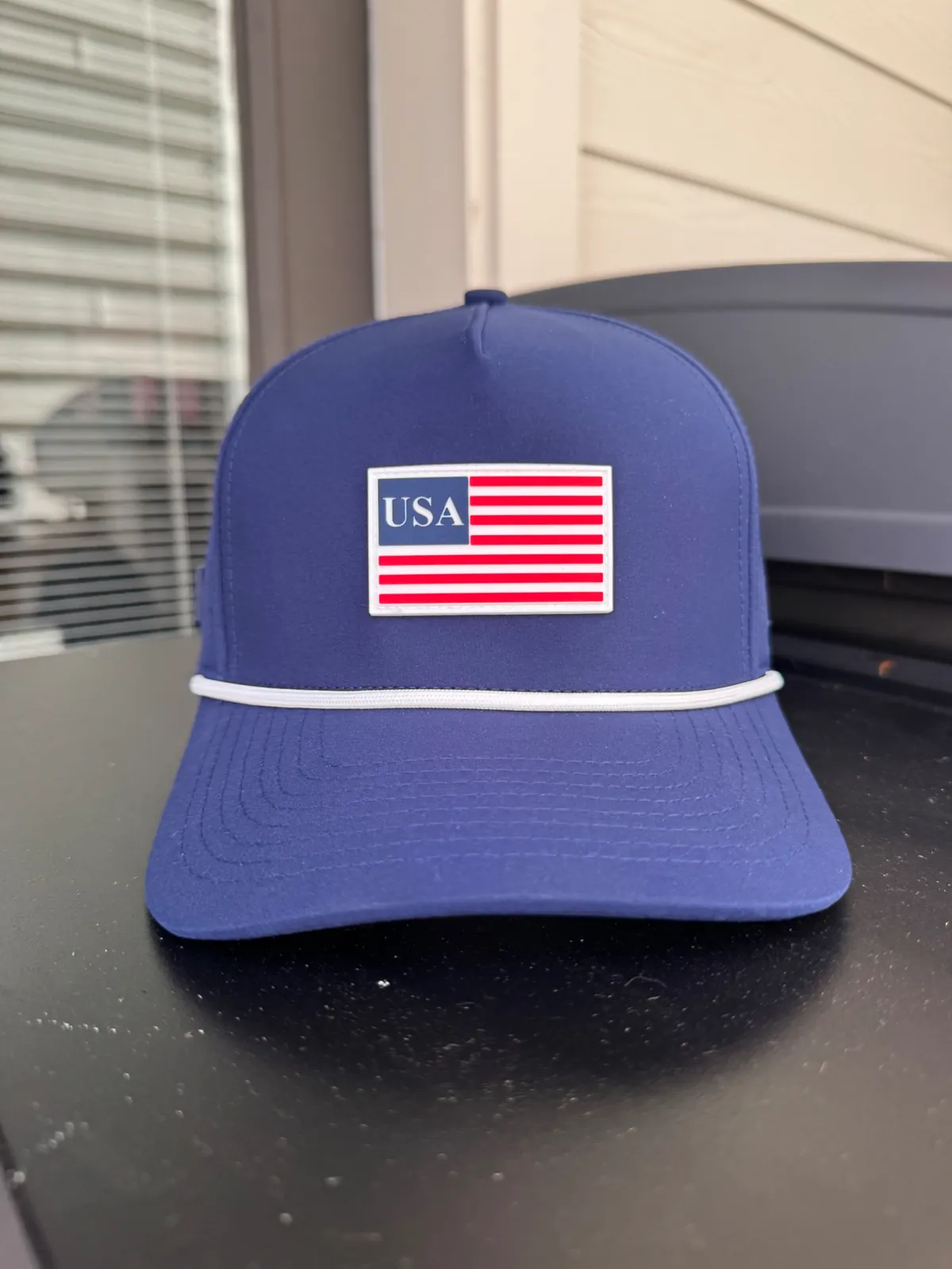 Navy business hat with an American flag patch and white rope